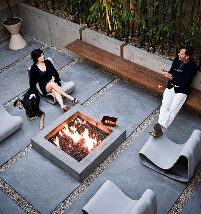 Couple relaxing around the fire with pet dog